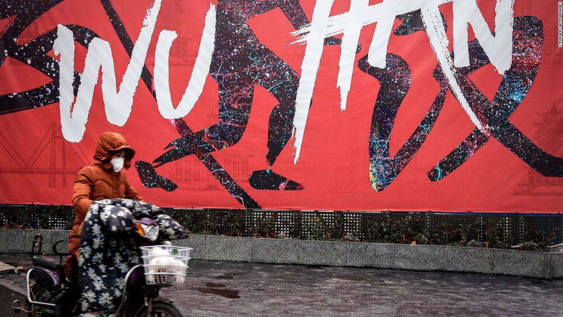 A woman rides an electric bicycle in Wuhan on January 22.